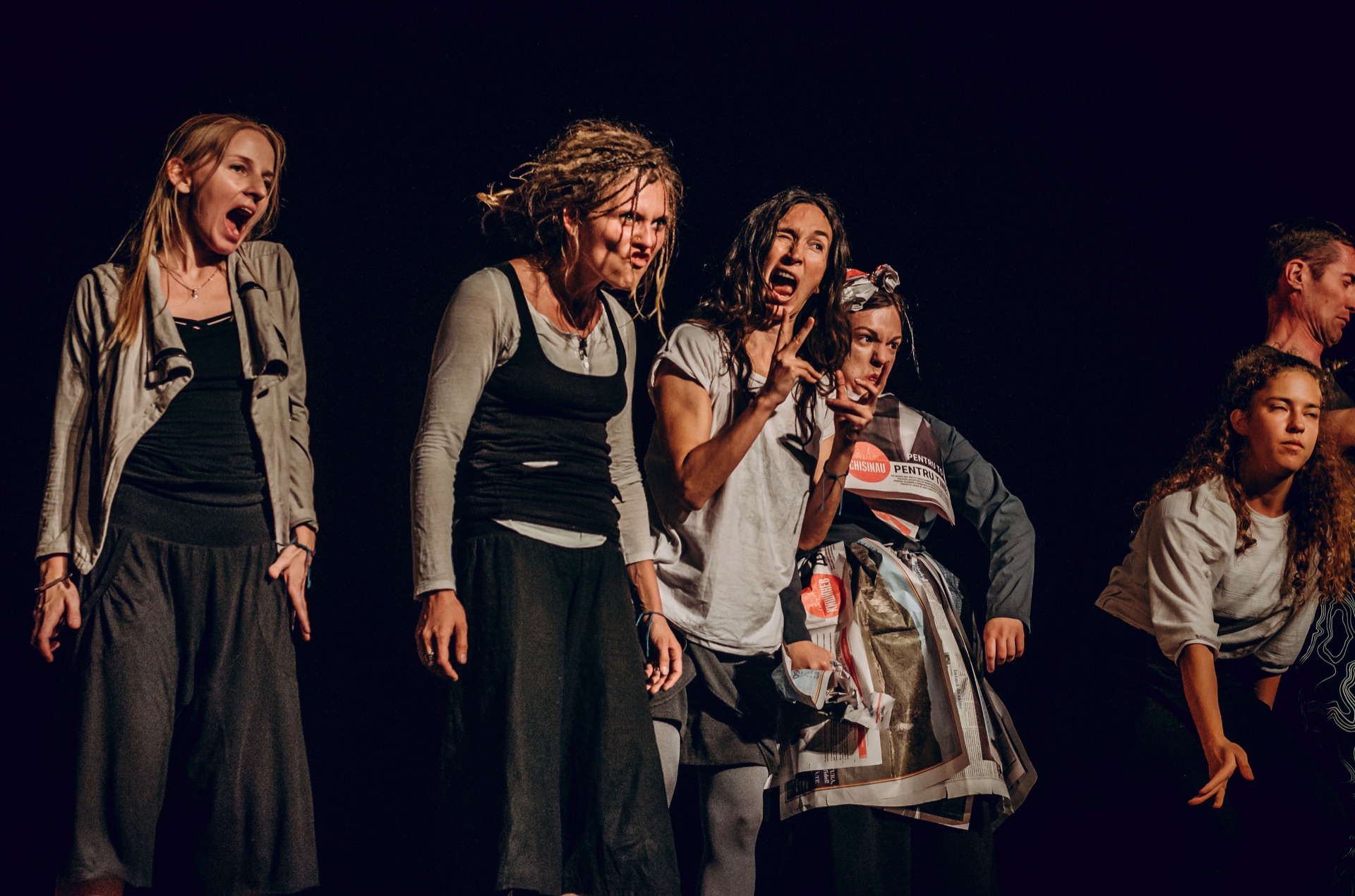 A group of performers sharing a vivid stage moment